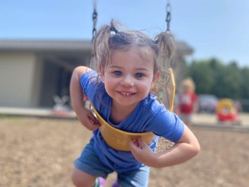 a little girl on a swing